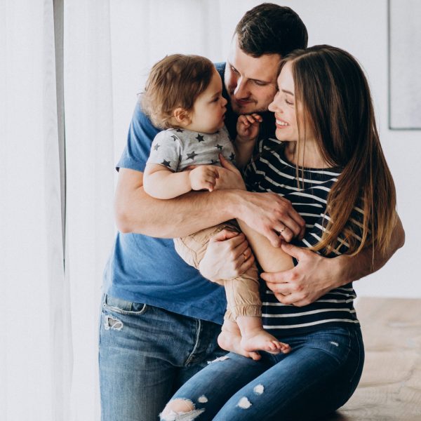 Young family with their little son at home